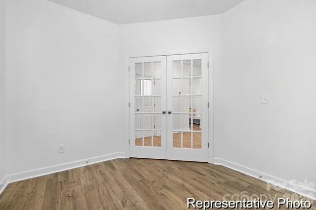 an empty room with wooden floor