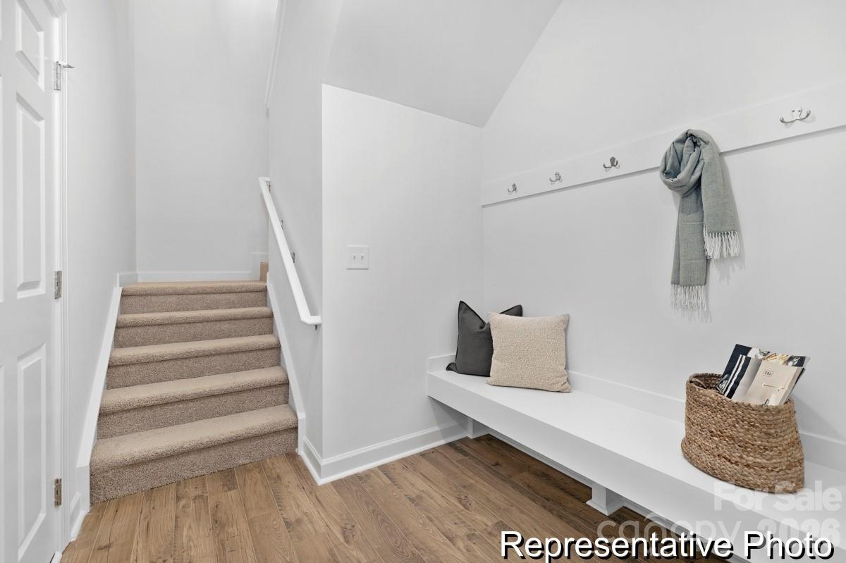 155 Soft Breeze Bend, Unit 286B Locust, NC 28097 - Photo 22 of 28 a white room with stairs and wooden floor
