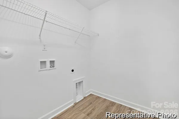 a view of a room with wooden floor