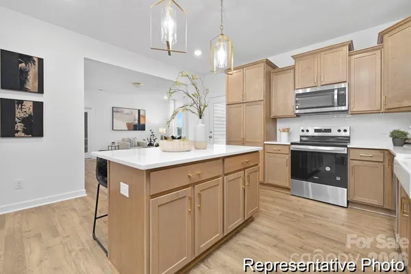 a kitchen with a sink cabinets stainless steel appliances and a counter top space
