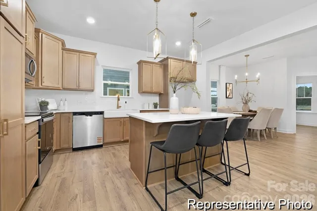 a kitchen with a sink cabinets and window