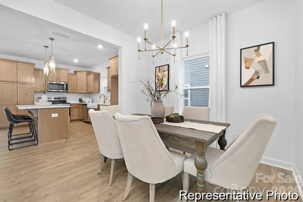 a living room with kitchen island furniture and a chandelier