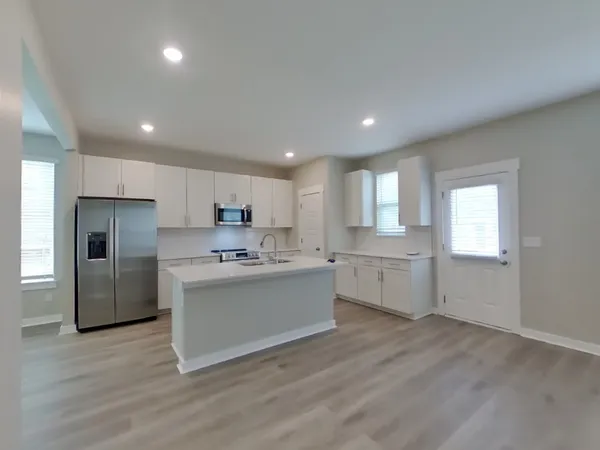 a kitchen with a sink stainless steel appliances and cabinets