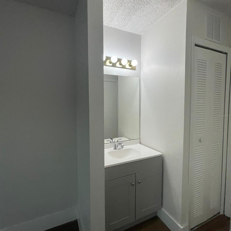 238 Afton Square, Unit 103 Altamonte Springs, FL 32714 - Photo 12 of 16 a bathroom with a sink and a mirror