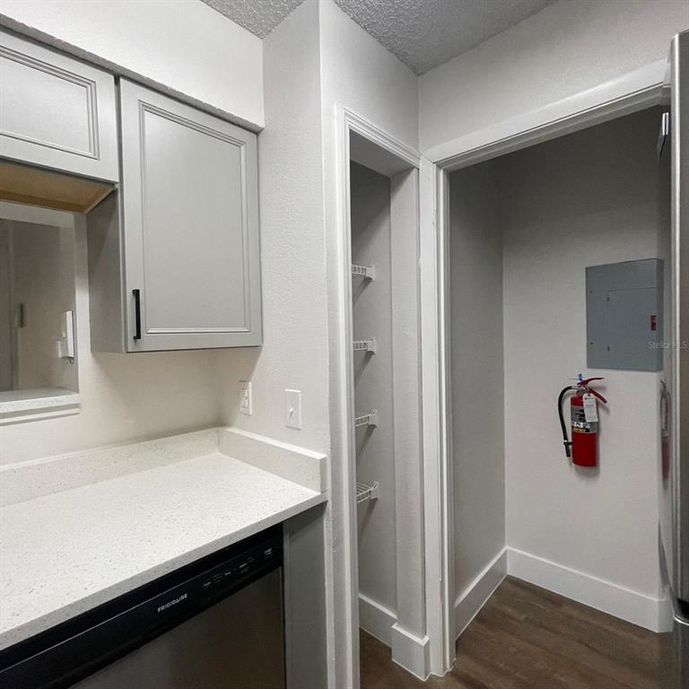 238 Afton Square, Unit 103 Altamonte Springs, FL 32714 - Photo 14 of 16 a room with a wooden floor and cabinets