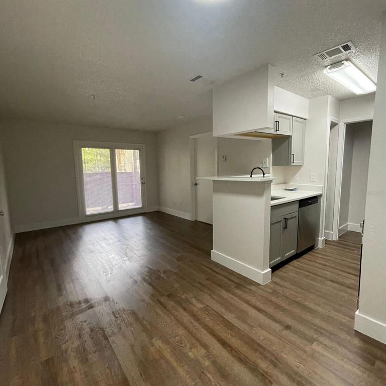 238 Afton Square, Unit 103 Altamonte Springs, FL 32714 - Photo 6 of 16 a kitchen with stainless steel appliances a white stove top oven and a refrigerator