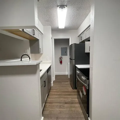 a kitchen with stainless steel appliances a refrigerator and a stove