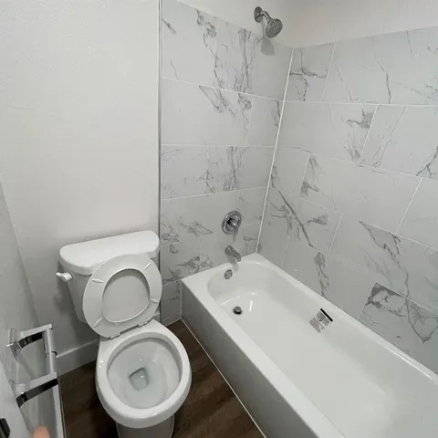 a bathroom with a sink a toilet and bathtub