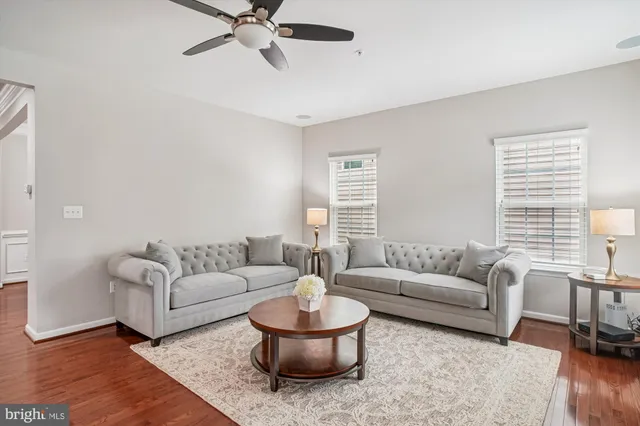 an empty room with a window and ceiling fan