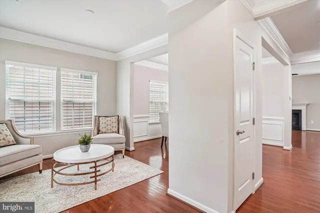 a view of a hallway with wooden floor and entryway