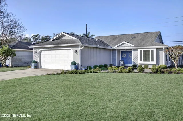 a front view of a house with a yard and garage