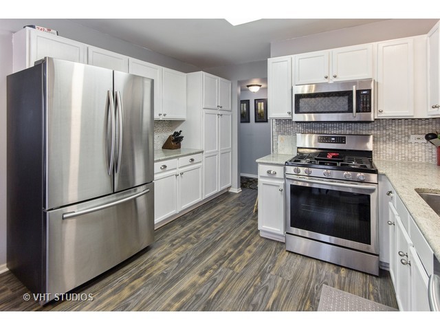 1909 Olde Mill Road Plainfield, IL 60586 - Photo 3 of 15 a kitchen with stainless steel appliances a stove a microwave and a refrigerator
