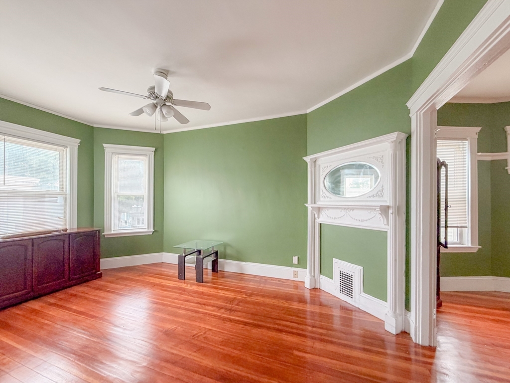 21 St Marks Road Boston, MA 02124 - Photo 9 of 30 a view of empty room with wooden floor and fan