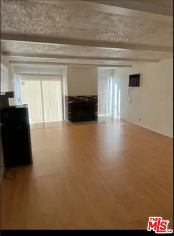 a view of empty room with a fireplace and cabinet
