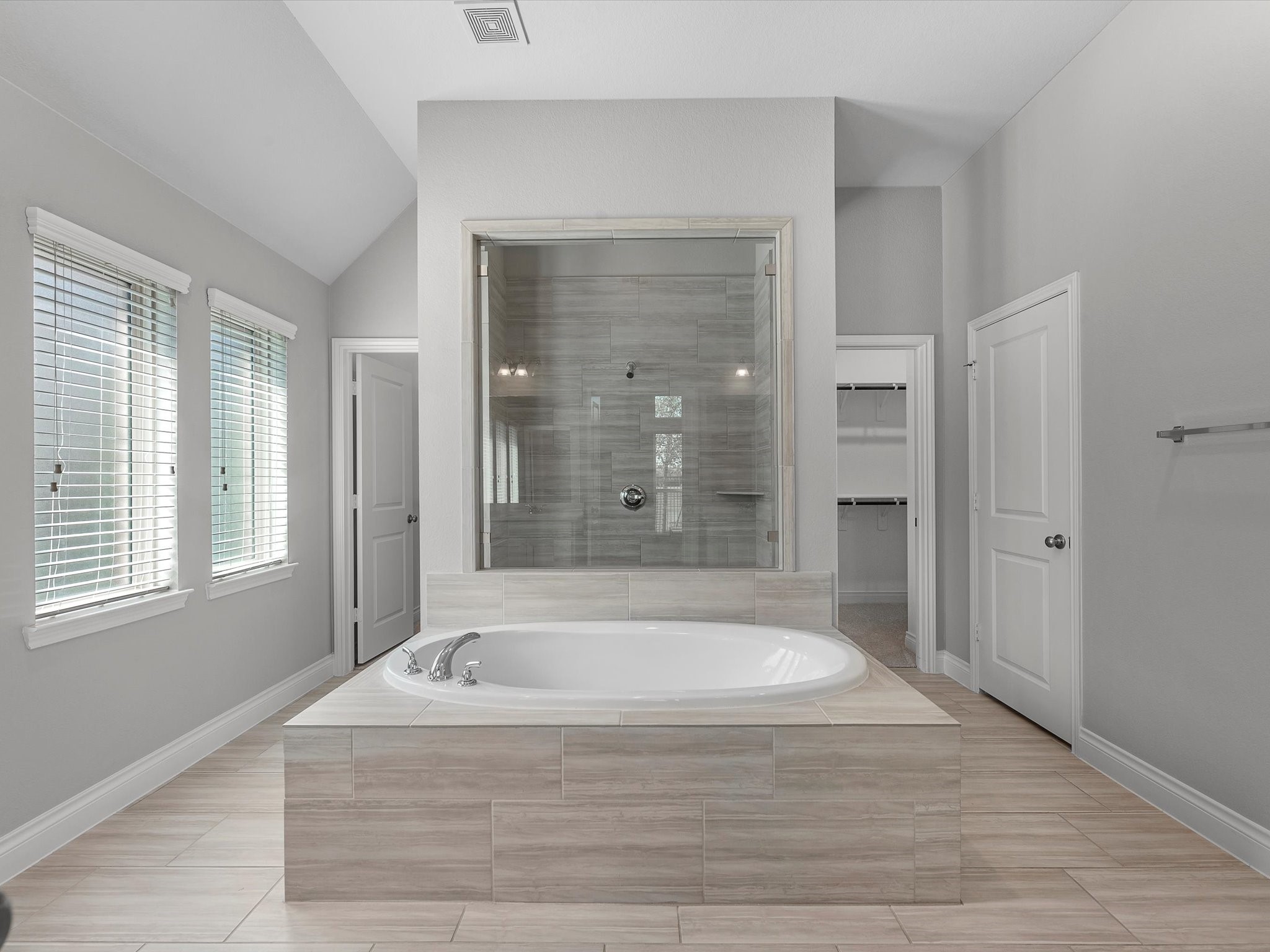 10135 Napier Drive Rosharon, TX 77583 - Photo 11 of 36 The primary bath is a highlight of the home, featuring a stunning entry with a freestanding soaking tub centered in front of a large dual-entry shower, flanked by his-and-her walk-in closets.