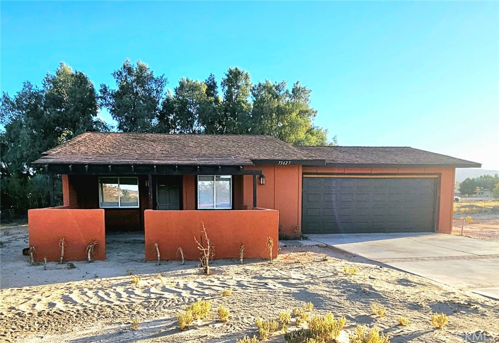 73627 Raymond Way Twentynine Palms, CA 92277 - Photo 1 of 16 a front view of a house with garden
