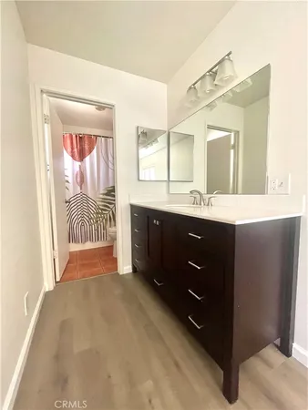 a bathroom with a sink double vanity and a mirror