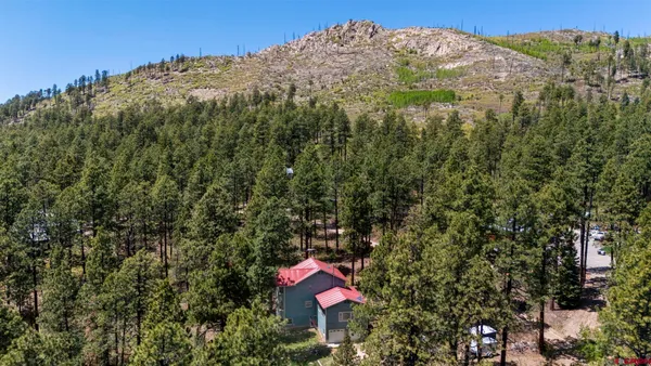 a view of a hallway with wooden floor and furniture
