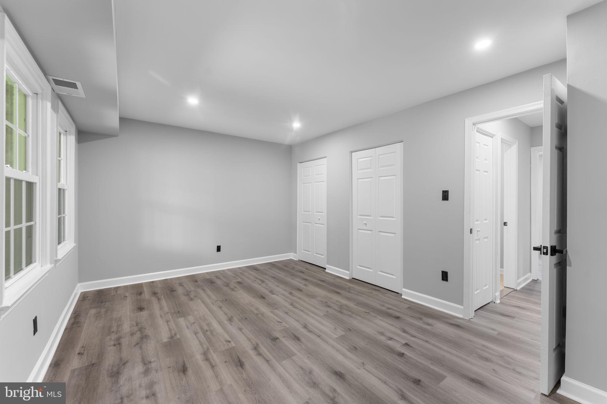 1044 A Ramsgate Court Sterling, VA 20164 - Photo 15 of 20 a view of an empty room with wooden floor and a window