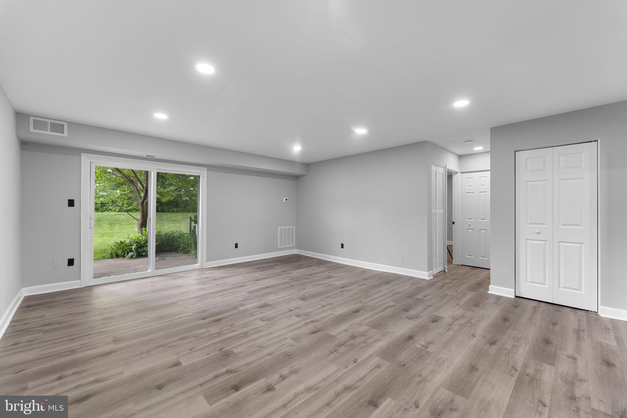 1044 A Ramsgate Court Sterling, VA 20164 - Photo 10 of 20 a view of an empty room with wooden floor and a window