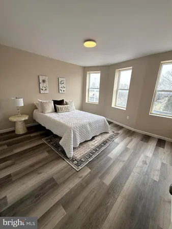 a spacious bedroom with a bed and window