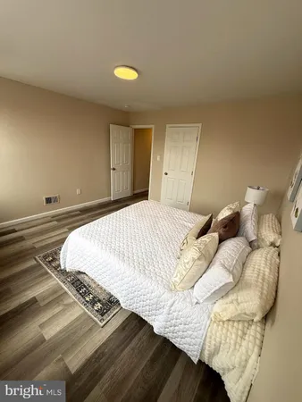 a bedroom with a bed and a lamp