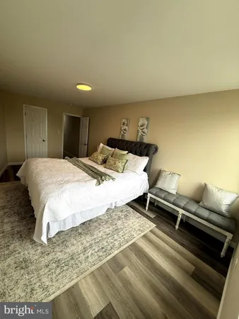 a bedroom with a bed and a couch