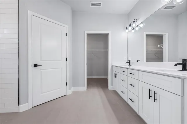 a bathroom with double sink and mirror
