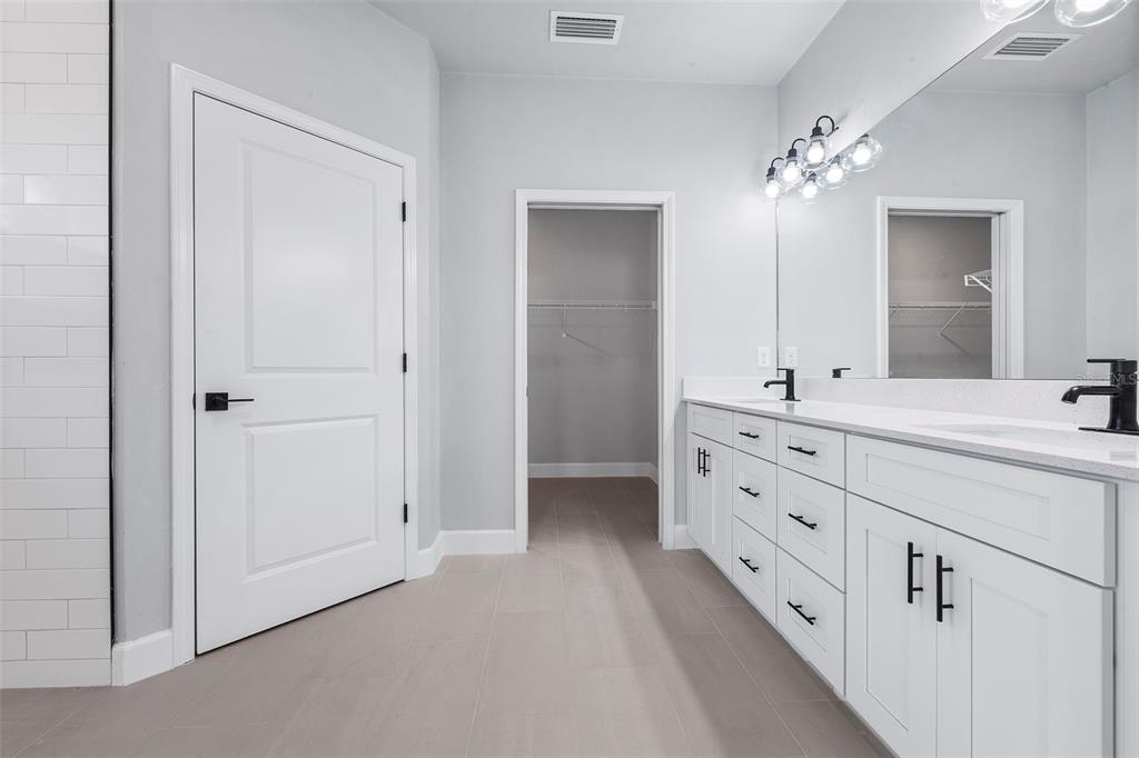 6703 Southwest 10th Lane Gainesville, FL 32607 - Photo 16 of 33 a bathroom with double sink and mirror