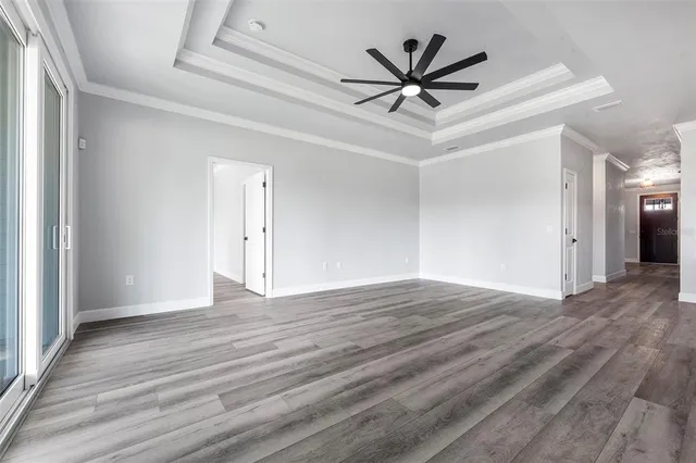 a view of kitchen and hall with wooden floor