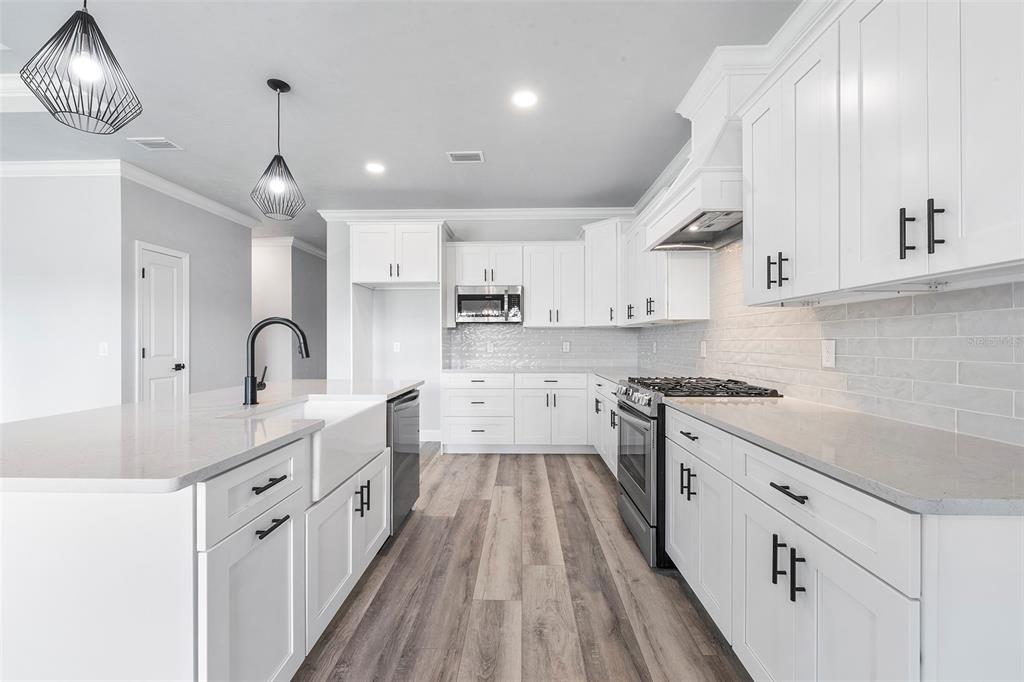6703 Southwest 10th Lane Gainesville, FL 32607 - Photo 22 of 33 a kitchen with white cabinets stainless steel appliances and sink