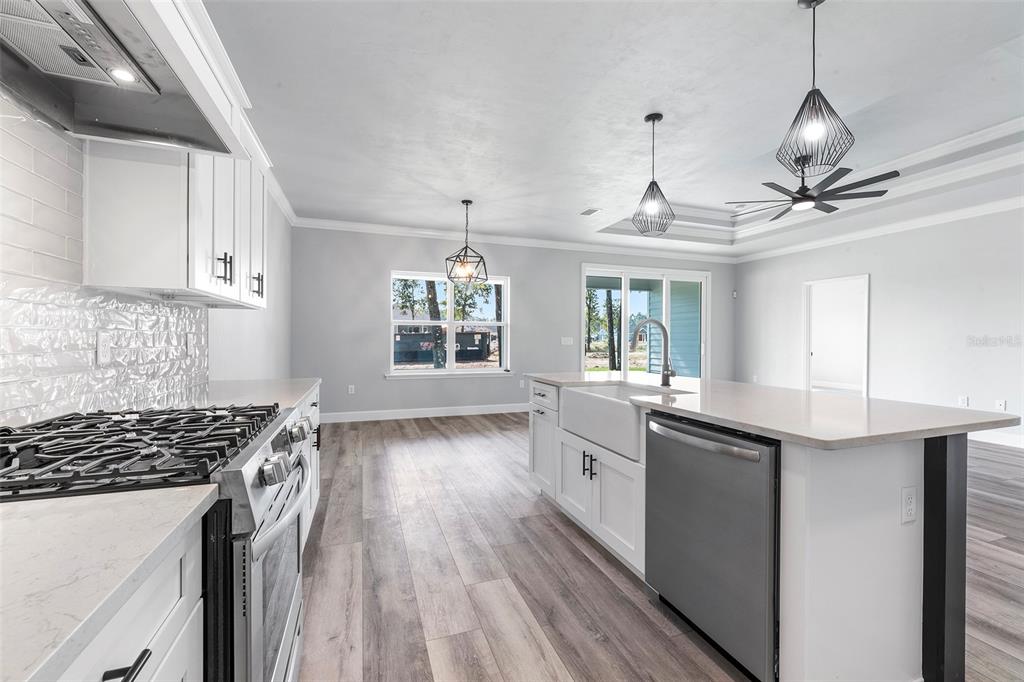 6703 Southwest 10th Lane Gainesville, FL 32607 - Photo 25 of 33 a kitchen with granite countertop a sink stove and cabinets
