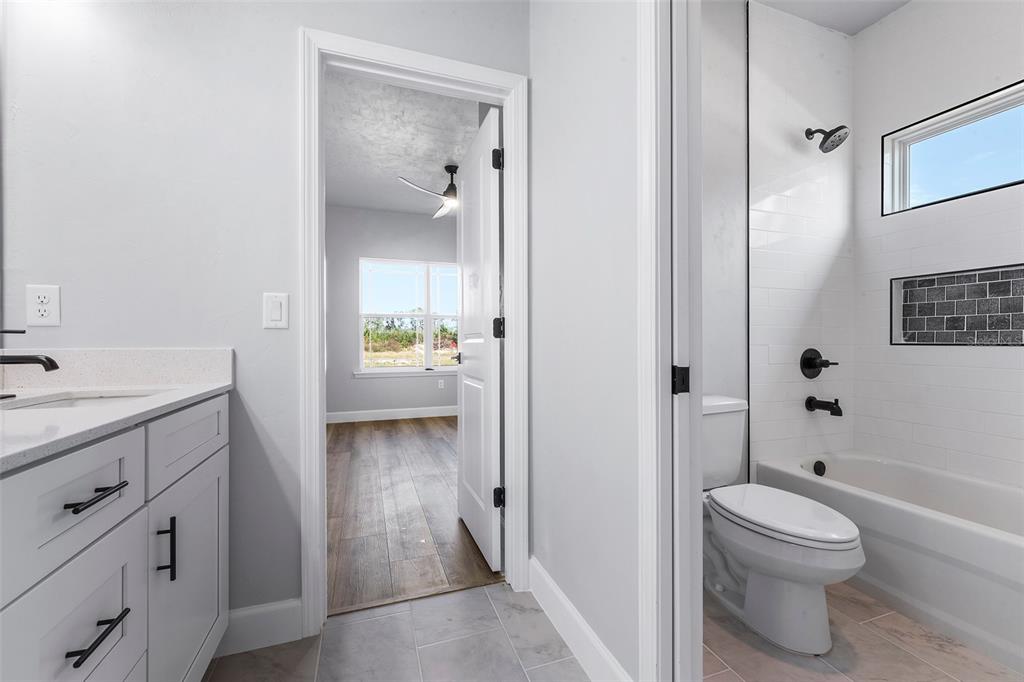 6703 Southwest 10th Lane Gainesville, FL 32607 - Photo 7 of 33 a bathroom with a sink a toilet and shower