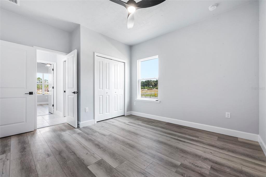 6703 Southwest 10th Lane Gainesville, FL 32607 - Photo 10 of 33 wooden floor in an empty room with a window