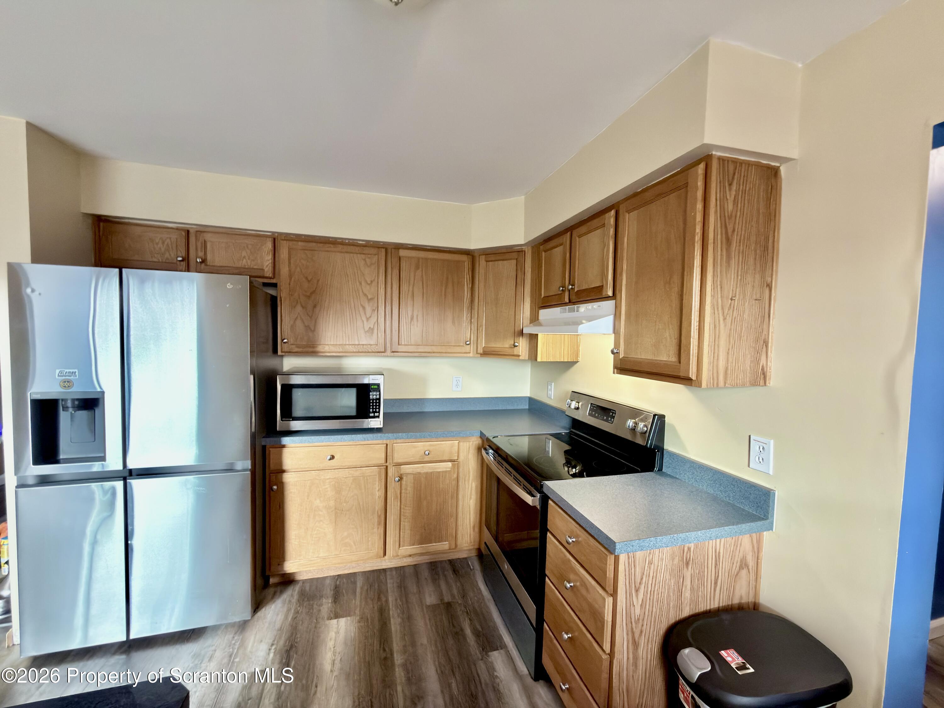 41 South Waterford Road Dalton, PA 18414 - Photo 8 of 22 a kitchen with a sink a refrigerator a stove and cabinets