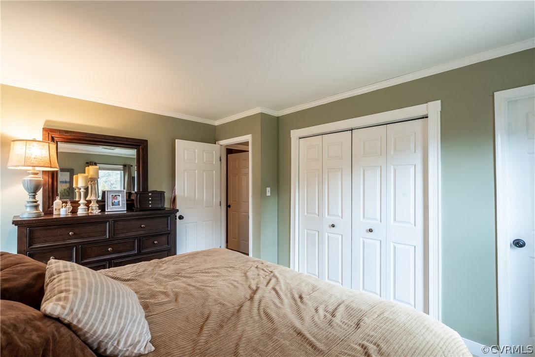 7900 Valencia Road Chesterfield, VA 23832 - Photo 34 of 44 a bedroom with a bed and wooden floor