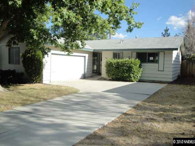 1265 Beldon Way Reno, NV 89503 - Photo 1 of 9 a front view of a house with a yard and garage