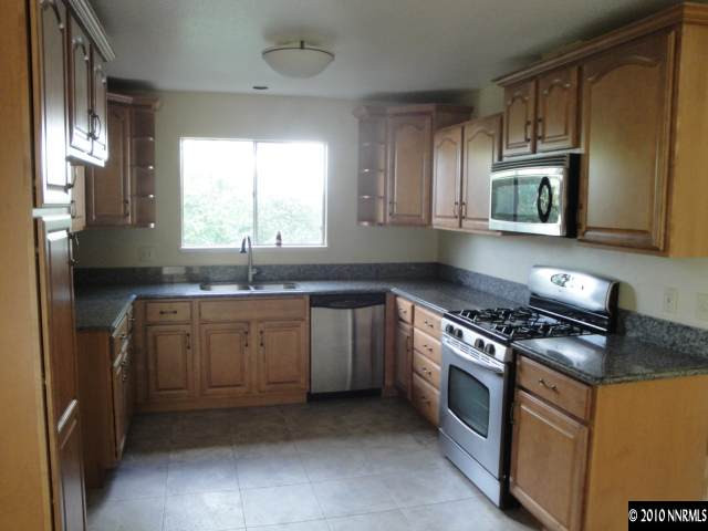 1265 Beldon Way Reno, NV 89503 - Photo 2 of 9 a kitchen with granite countertop a sink a stove and cabinets