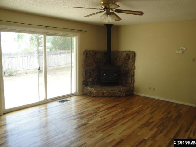 1265 Beldon Way Reno, NV 89503 - Photo 4 of 9 a view of an empty room with wooden floor and a window
