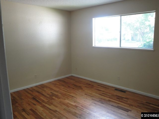 1265 Beldon Way Reno, NV 89503 - Photo 5 of 9 an empty room with wooden floor and windows