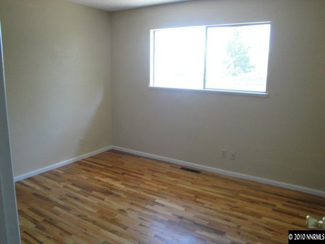 1265 Beldon Way Reno, NV 89503 - Photo 7 of 9 an empty room with wooden floor and windows