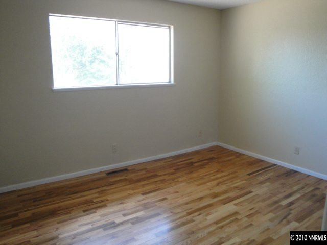 1265 Beldon Way Reno, NV 89503 - Photo 8 of 9 an empty room with wooden floor and windows