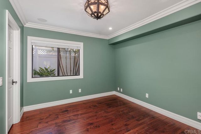 a view of a room with wooden floor and a window