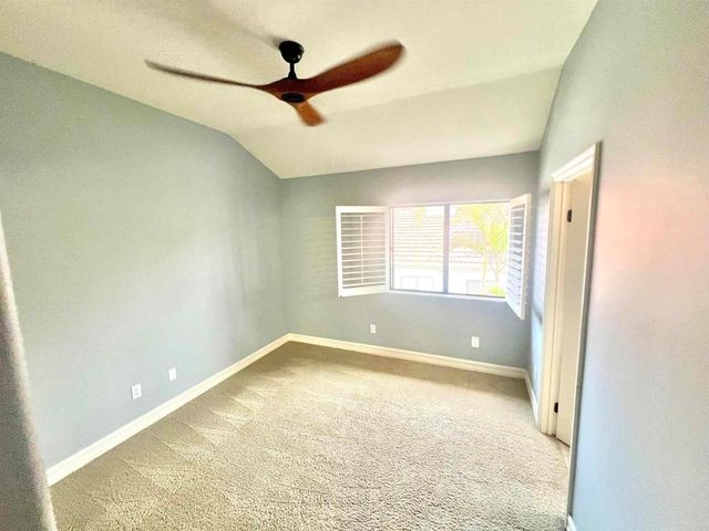 a view of room with a ceiling fan and window