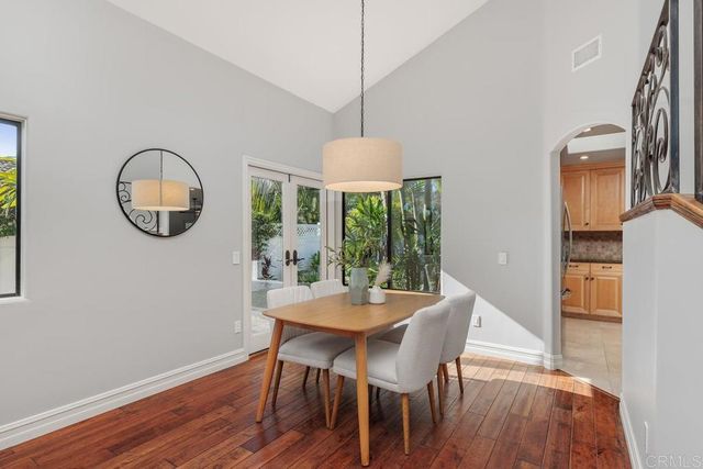 a dining room with furniture a window and wooden floor