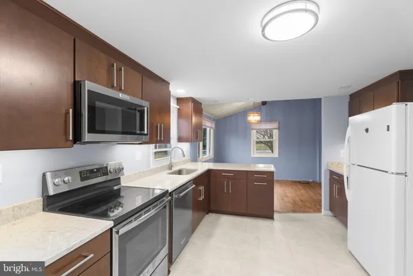a kitchen with a sink appliances and cabinets