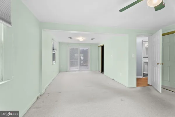 an empty room with a empty space and windows