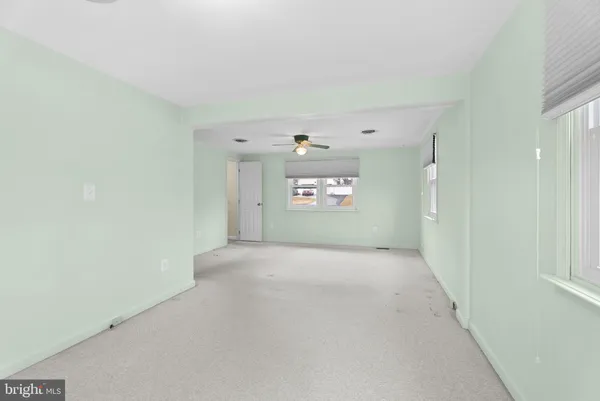 a view of room with a ceiling fan and window