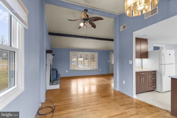 a view of livingroom with hardwood floor and a ceiling fan