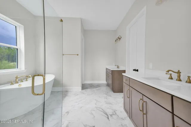 a white bath tub sitting next to a white sink